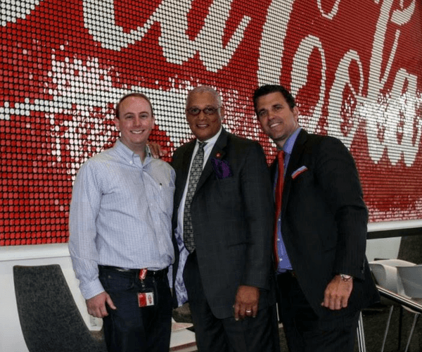 Three men in suits and ties standing next to each other.